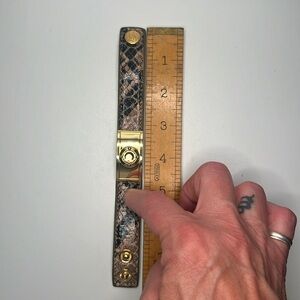 Snakeskin print bracelet snap closure with gold tone and stone medallion!